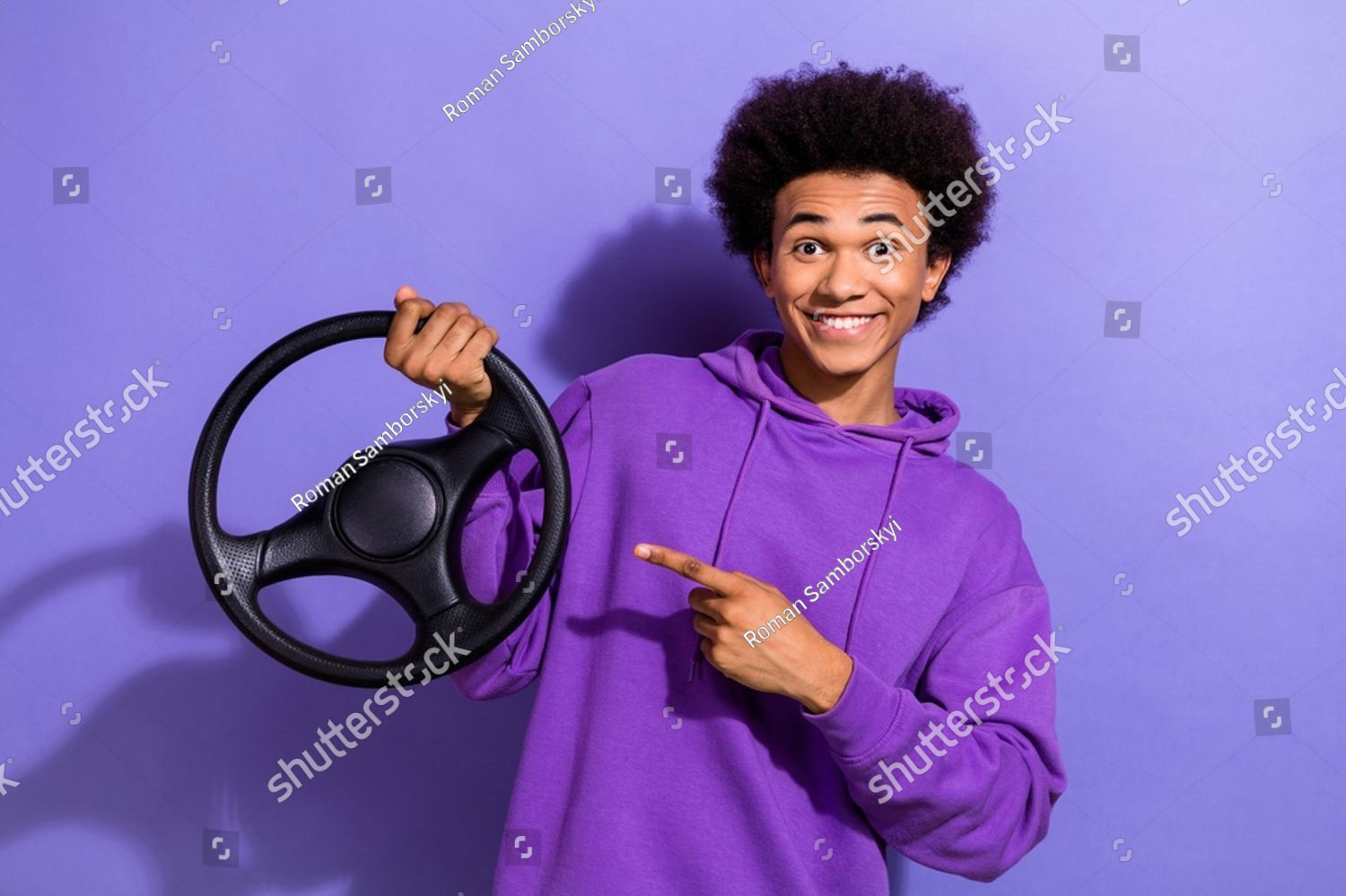 stock-photo-portrait-of-cheerful-person-wear-violet-hoodie-hold-steering-wheel-directing-at-steering-wheel-2317817203-2